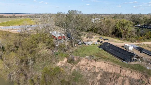 a aerial view of a house with a yard and lake view