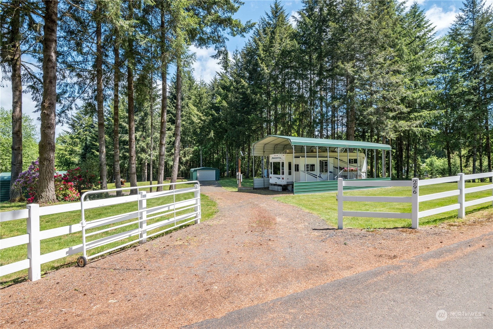 296 Cedar Hills Road Longview, WA 98632 - Photo 1 of 27 a view of a house with a small yard and large trees