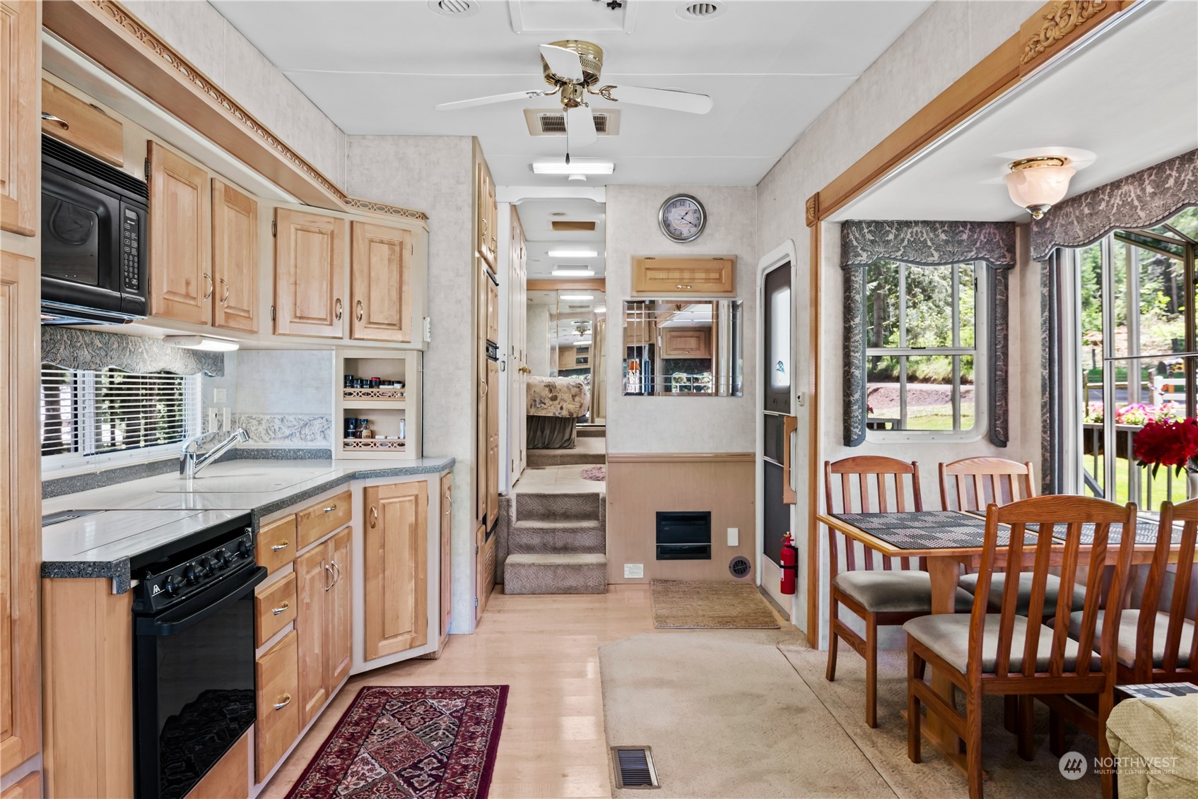 296 Cedar Hills Road Longview, WA 98632 - Photo 19 of 27 a kitchen with stainless steel appliances granite countertop a stove top oven a sink dishwasher a dining table and chairs with wooden floor