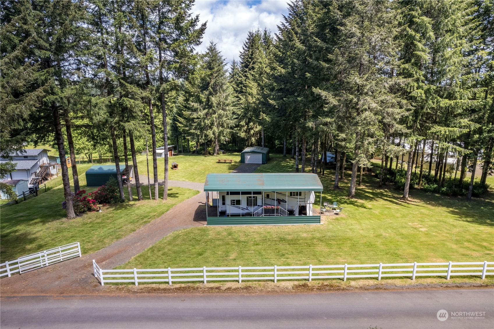 296 Cedar Hills Road Longview, WA 98632 - Photo 2 of 27 a view of a swimming pool with an outdoor seating and a yard