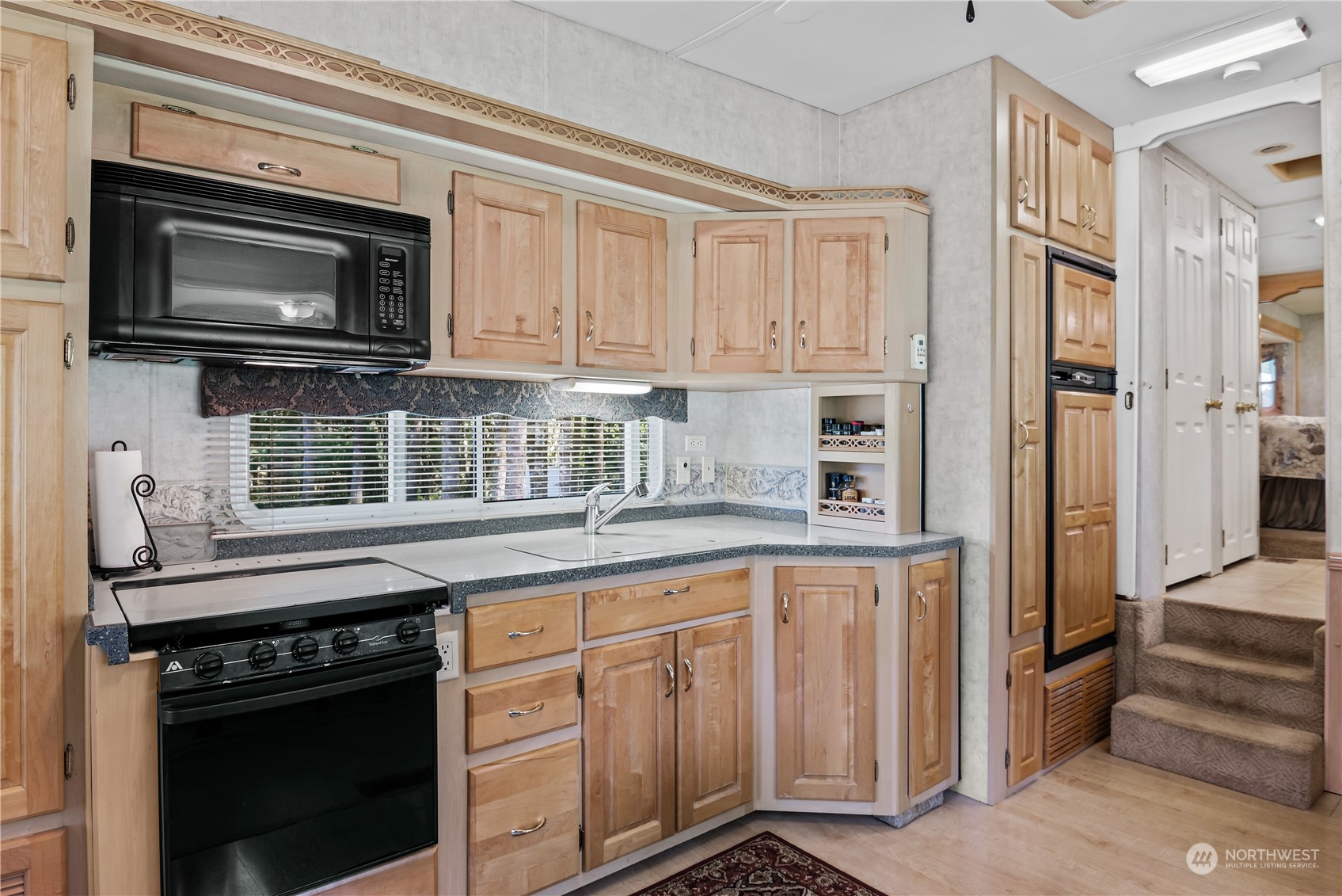 296 Cedar Hills Road Longview, WA 98632 - Photo 21 of 27 a kitchen with stainless steel appliances granite countertop a stove microwave and cabinets