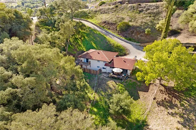 an aerial view of a house with a yard
