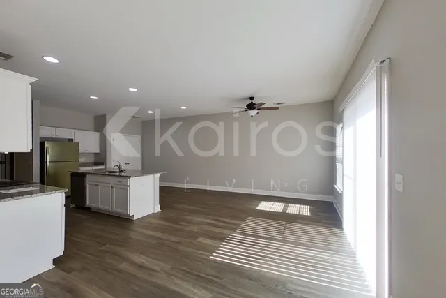 a kitchen with stainless steel appliances granite countertop a stove a sink and a refrigerator