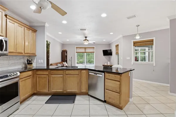 a kitchen with a sink window and cabinets