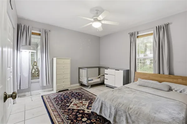 a bedroom with a large bed and a chandelier