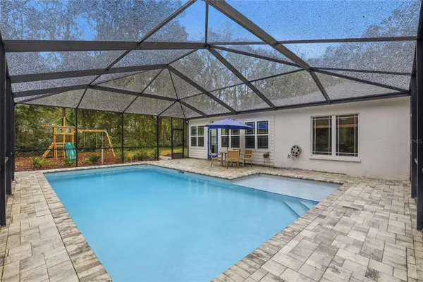 a view of a backyard with swimming pool