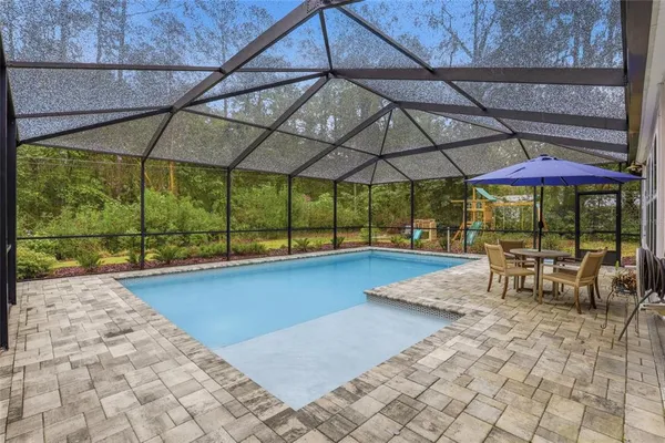 a view of a swimming pool with a patio