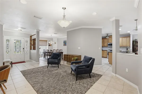 a living room with furniture and kitchen view