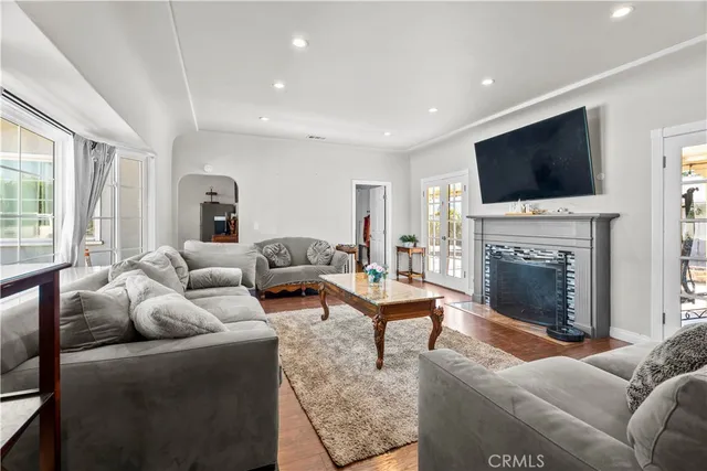 a living room with furniture a flat screen tv and a fireplace