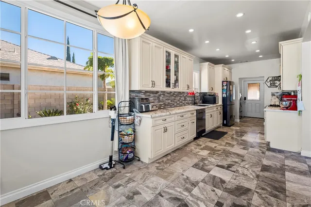 a kitchen with a sink stove and cabinets