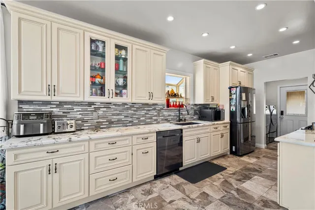 a kitchen with granite countertop white cabinets and white appliances