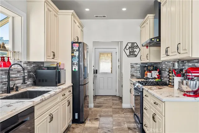 a kitchen with a sink cabinets and refrigerator