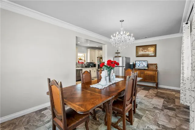 a view of a dining room with furniture and chandelier