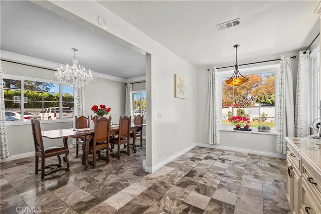 a view of a dining room with furniture window and outdoor view