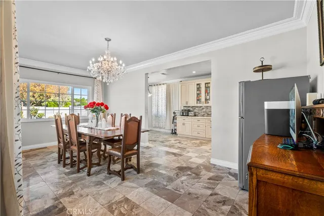a view of a dining room with furniture and chandelier