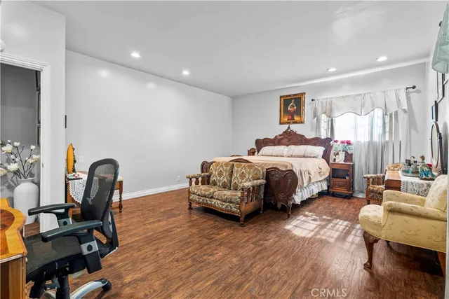 a bedroom with furniture and a wooden floor