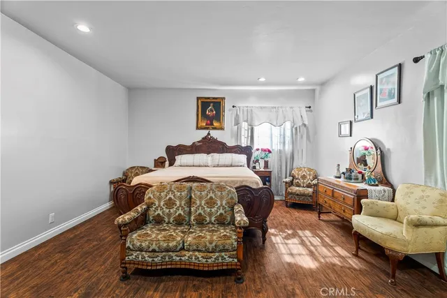 a bedroom with a bed and a couch