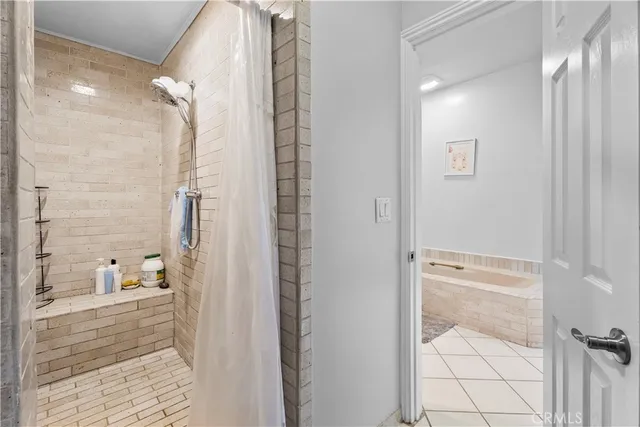 a bathroom with a glass shower door and a bathtub