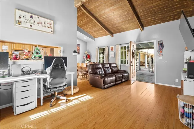 a living room with furniture a wooden floor and a large window