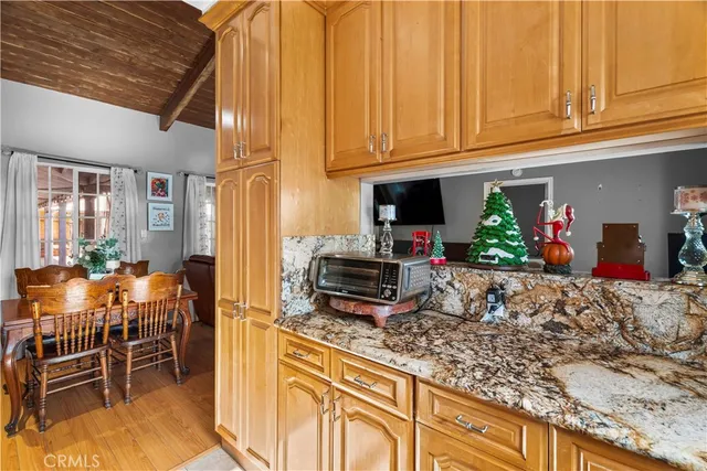 a kitchen with stainless steel appliances granite countertop a stove and cabinets
