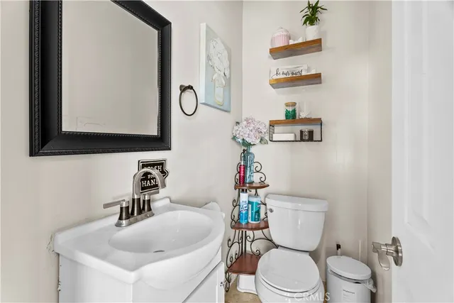 a white toilet sitting next to a bathroom sink