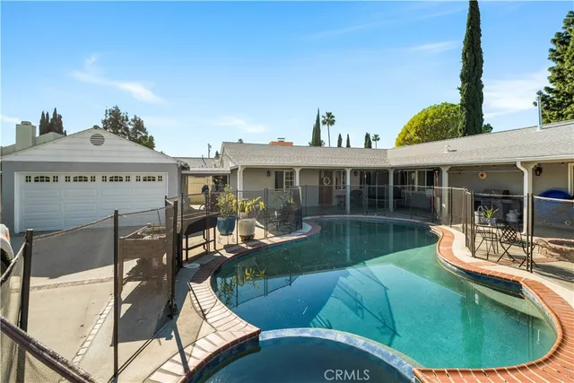 a view of a house with swimming pool and sitting area