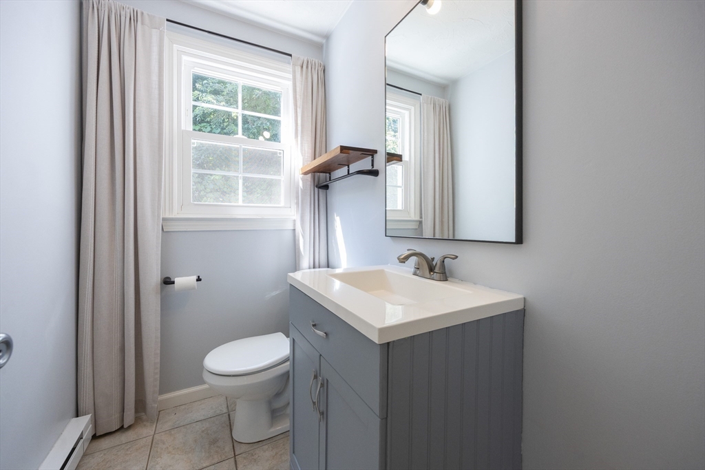 19 Cedar Square, Unit 19 Millis, MA 02054 - Photo 15 of 42 a bathroom with a toilet sink and mirror