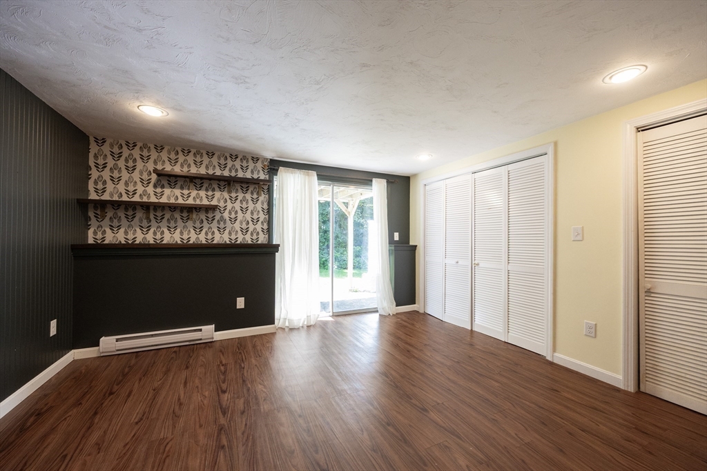19 Cedar Square, Unit 19 Millis, MA 02054 - Photo 32 of 42 a view of an empty room with wooden floor and a window