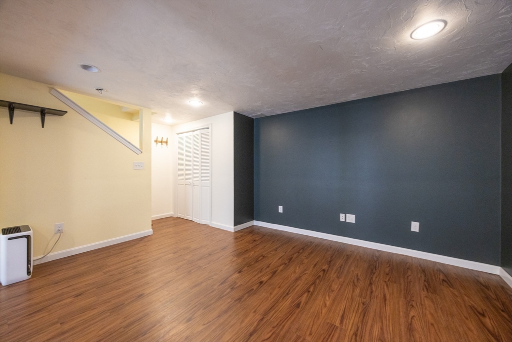 19 Cedar Square, Unit 19 Millis, MA 02054 - Photo 33 of 42 a view of an empty room with wooden floor