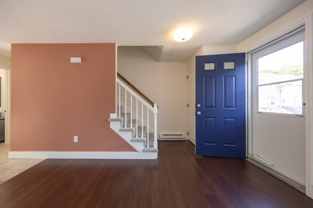 19 Cedar Square, Unit 19 Millis, MA 02054 - Photo 5 of 42 an empty room with wooden floor and windows