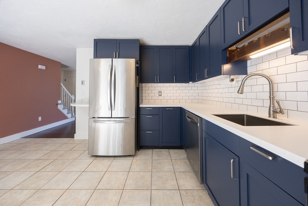 19 Cedar Square, Unit 19 Millis, MA 02054 - Photo 10 of 42 a kitchen with stainless steel appliances a refrigerator a sink a stove a microwave and cabinets