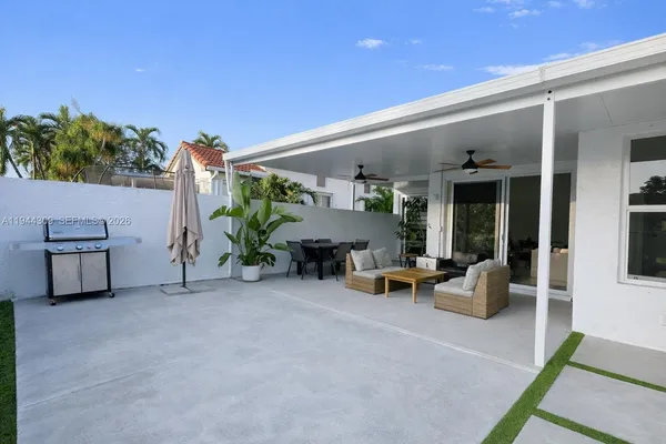 a view of a porch with furniture and a yard