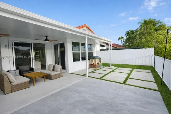 a view of a house with backyard porch and sitting area