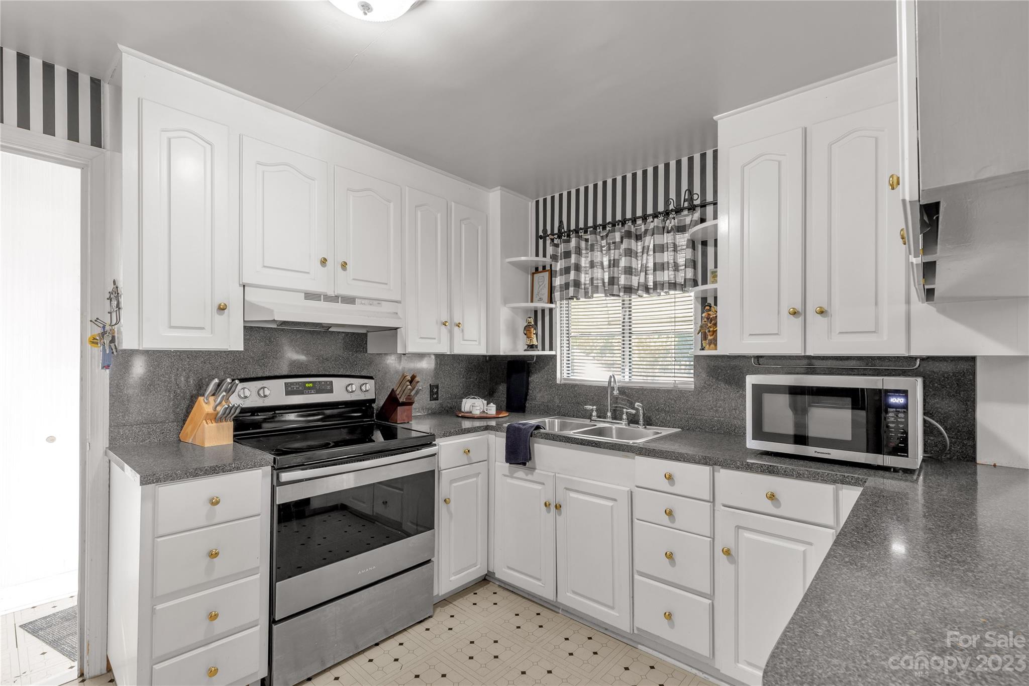 401 Gillsbrook Road Lancaster, SC 29720 - Photo 10 of 27 a kitchen with white cabinets and appliances
