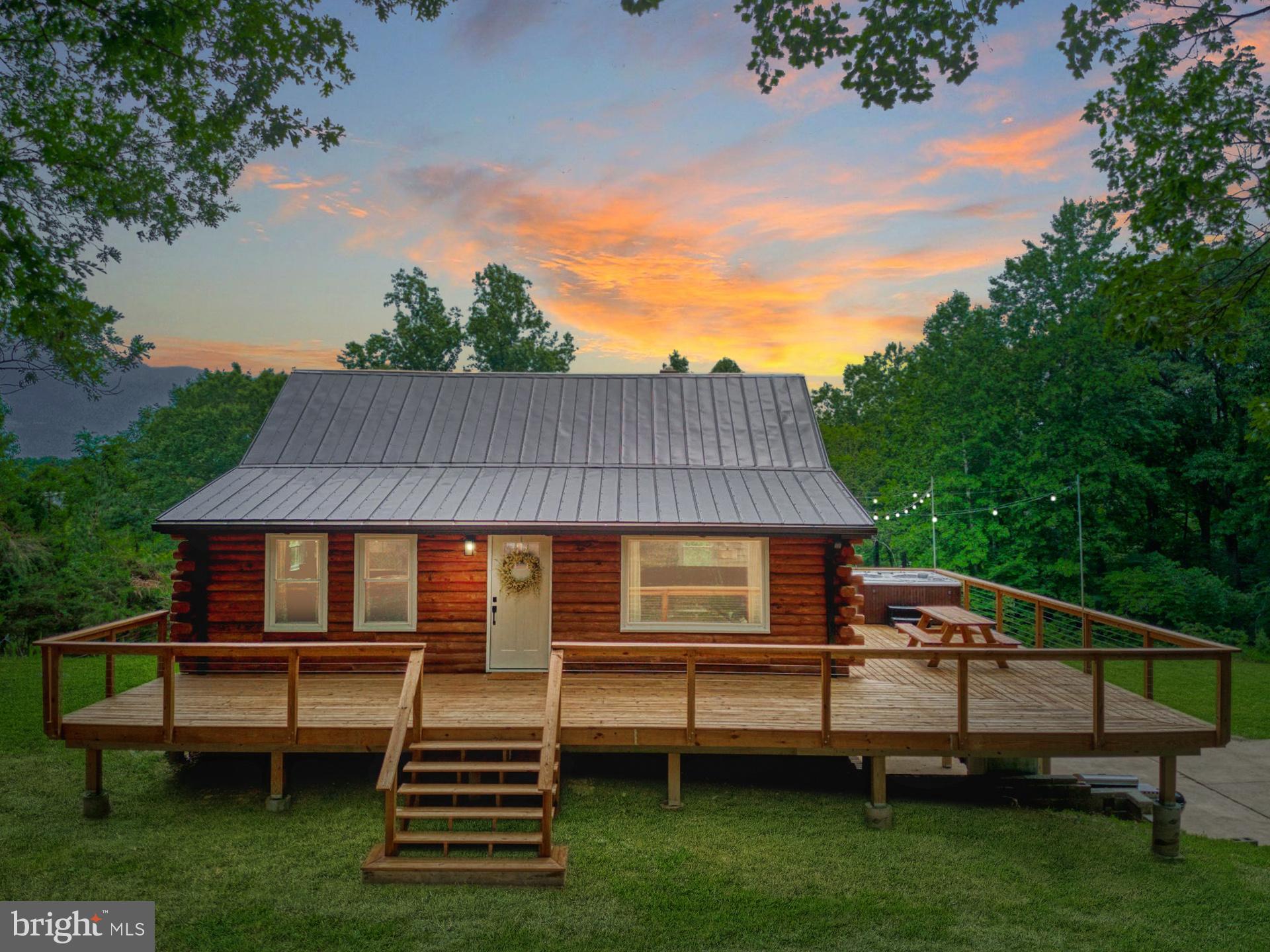 14422 Crawleys Dam Road Goldvein, VA 22720 - Photo 1 of 41 a backyard of a house with wooden deck and outdoor seating
