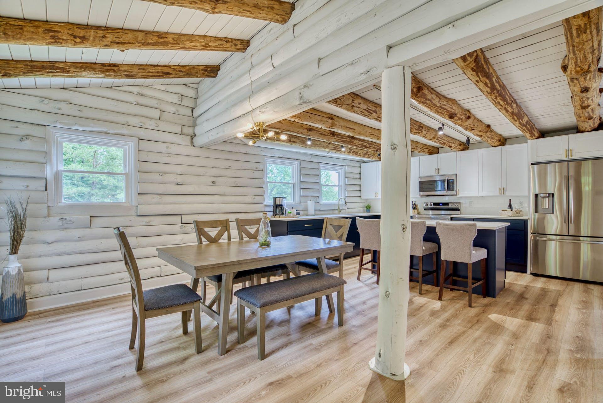 14422 Crawleys Dam Road Goldvein, VA 22720 - Photo 11 of 41 a dining room with furniture a rug and wooden floor