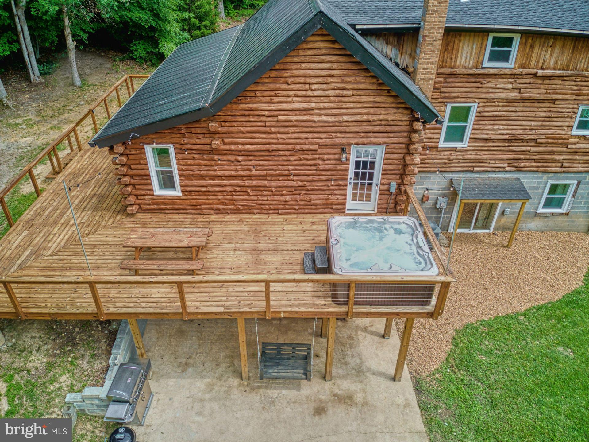 14422 Crawleys Dam Road Goldvein, VA 22720 - Photo 20 of 41 a view of house with backyard outdoor seating area and furniture