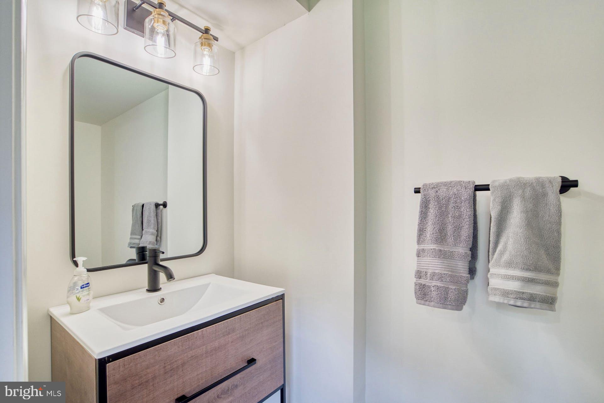 14422 Crawleys Dam Road Goldvein, VA 22720 - Photo 27 of 41 a bathroom with a sink and mirror