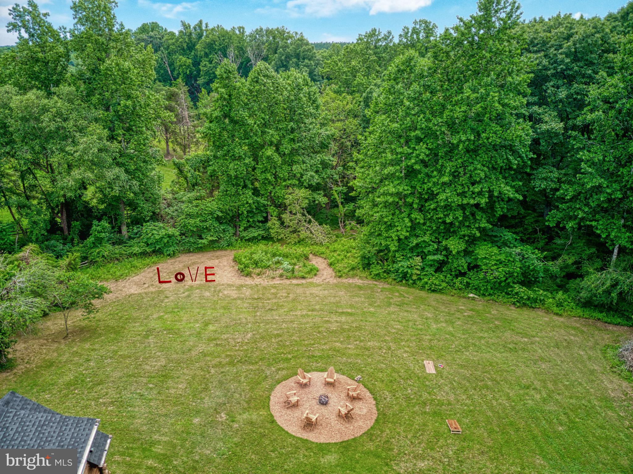 14422 Crawleys Dam Road Goldvein, VA 22720 - Photo 37 of 41 a view of a table and chairs in the garden