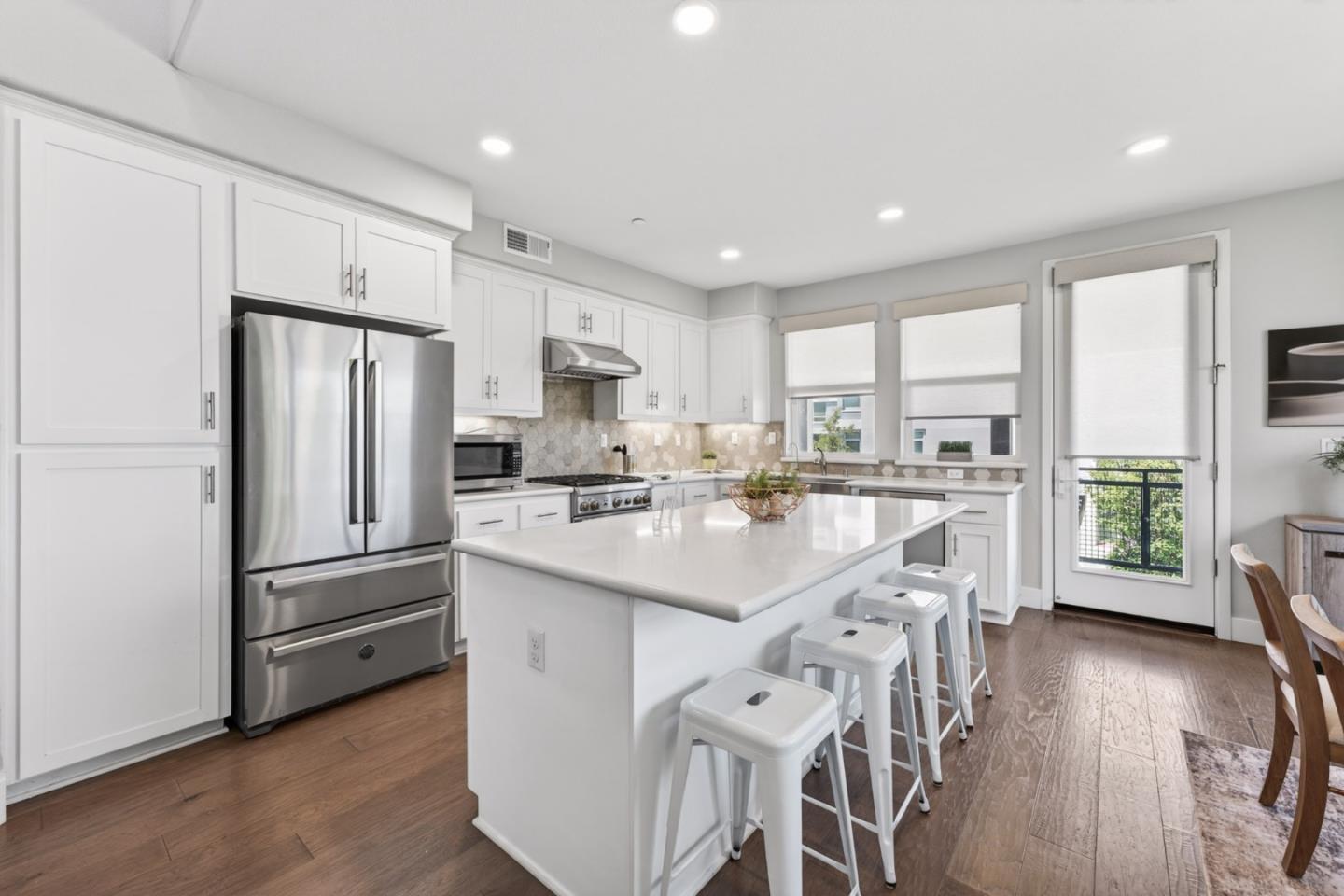 202 Market Street Milpitas, CA 95035 - Photo 2 of 30 a kitchen with stainless steel appliances a refrigerator a sink a stove a microwave a center island and a window