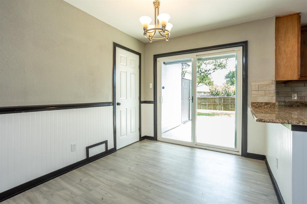 1206 Oakbluff Drive Lancaster, TX 75146 - Photo 10 of 23 Dining area has plank flooring.