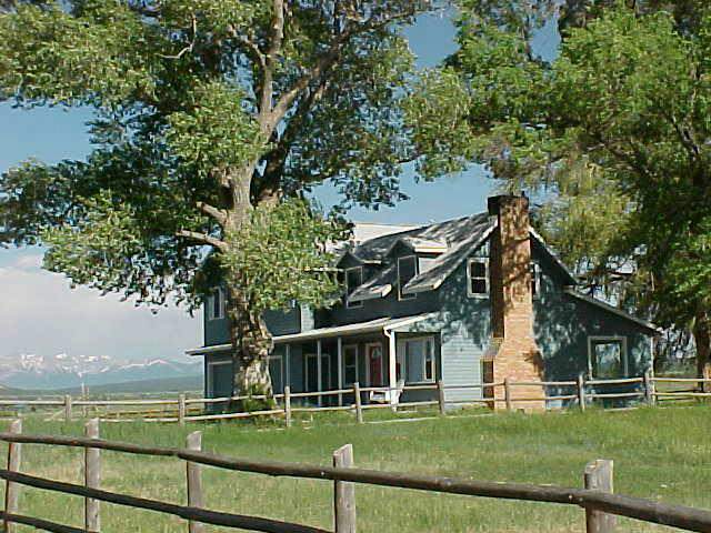 514-42 Z Road Telluride, CO 81435 - Photo 1 of 9 a view of a white house with a big yard and potted plants and large trees