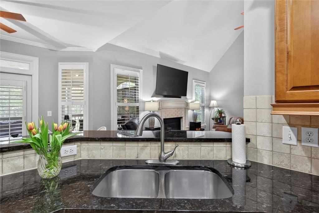 129 Dorchester Way Villa Rica, GA 30180 - Photo 13 of 65 a kitchen with sink a potted plant and a window