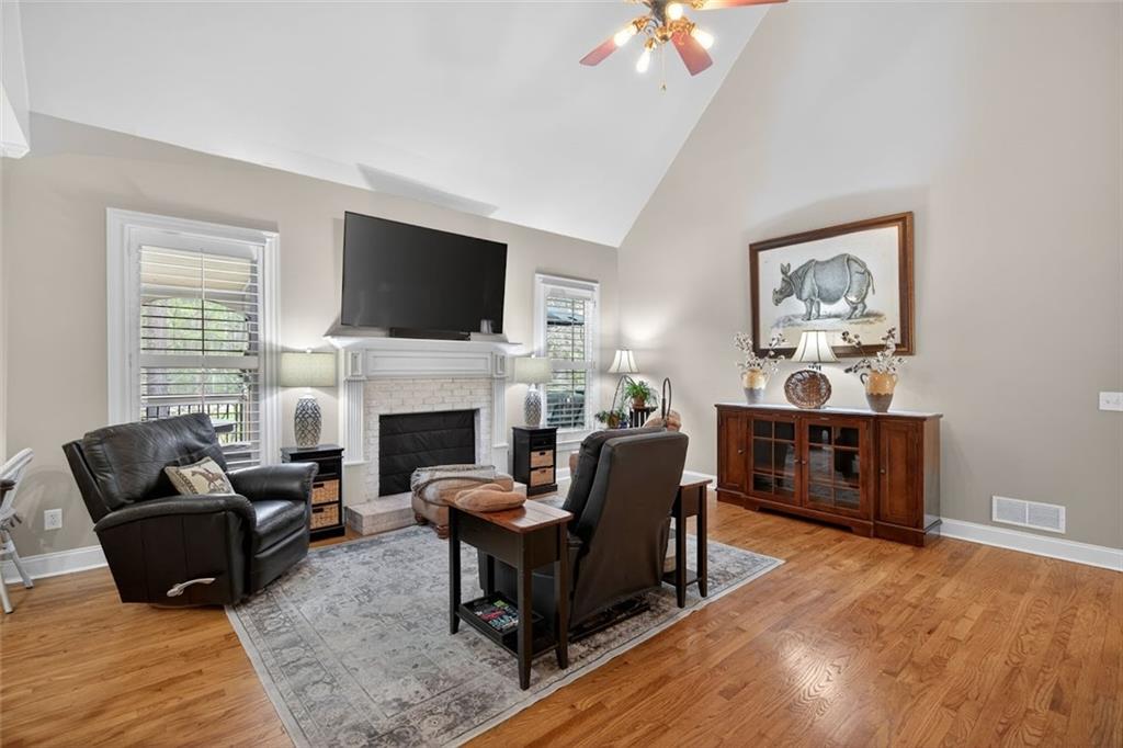 129 Dorchester Way Villa Rica, GA 30180 - Photo 18 of 65 a living room with furniture a flat screen tv and a fireplace