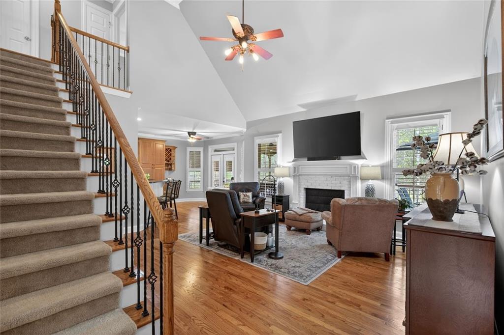 129 Dorchester Way Villa Rica, GA 30180 - Photo 19 of 65 a living room with furniture a fireplace and a flat screen tv