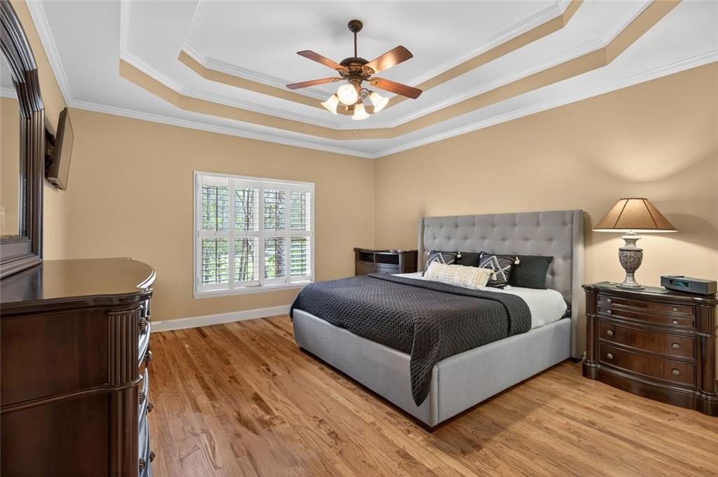 129 Dorchester Way Villa Rica, GA 30180 - Photo 23 of 65 a bedroom with a bed and a chandelier