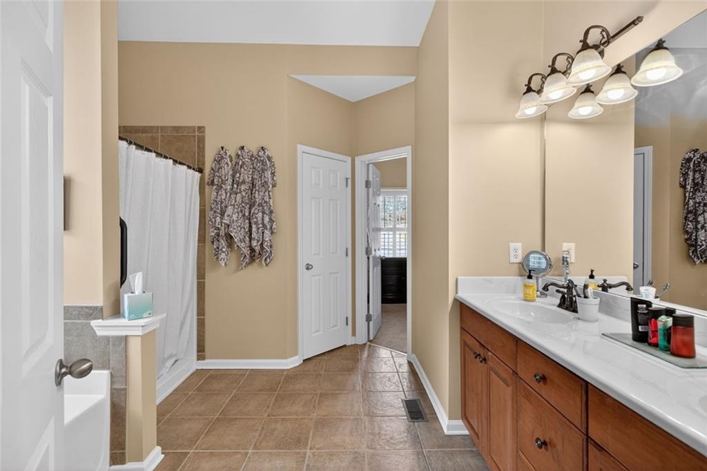 129 Dorchester Way Villa Rica, GA 30180 - Photo 24 of 65 a spacious bathroom with a double vanity sink a mirror a and a shower