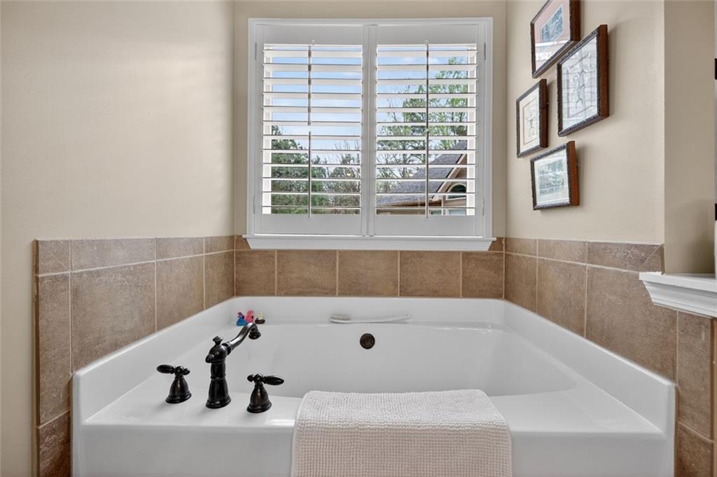 129 Dorchester Way Villa Rica, GA 30180 - Photo 26 of 65 a bathroom with a bathtub