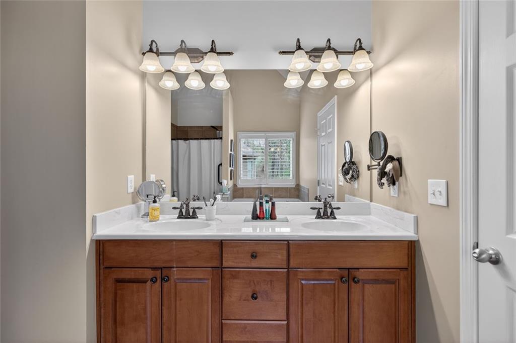 129 Dorchester Way Villa Rica, GA 30180 - Photo 27 of 65 a bathroom with a sink vanity and mirror