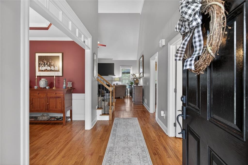 129 Dorchester Way Villa Rica, GA 30180 - Photo 3 of 65 a view of a hallway with wooden floor and a living room